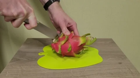 Cutting dragon fruit with a knife. Pitaya. Pitahaya. Stock Footage 231243152