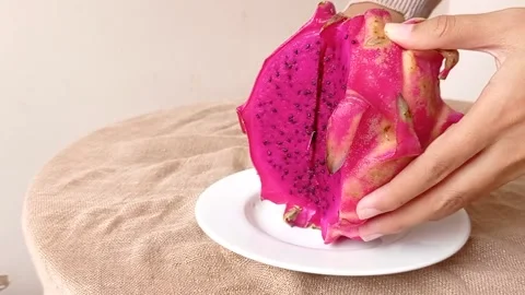 Cutting a dragon fruit with a small fruit knife Stock Footage 146253393