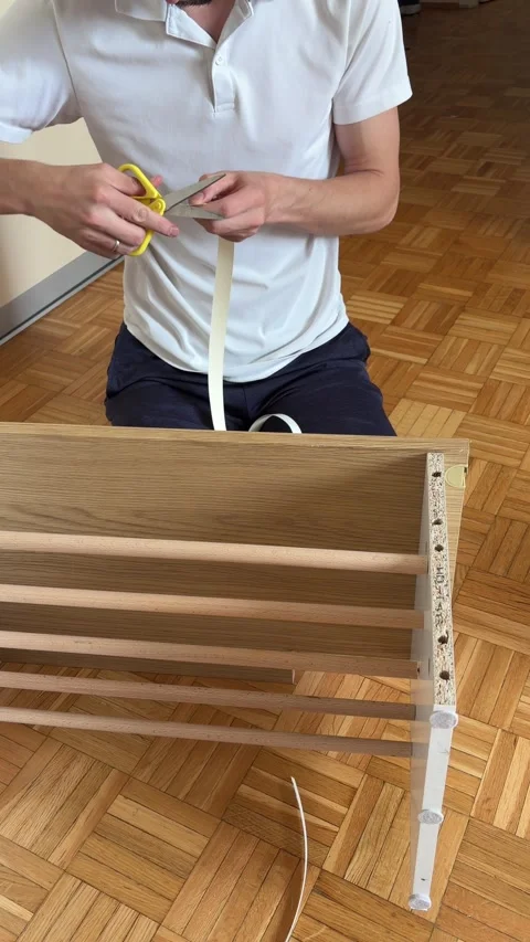 Cutting edge banding to length with scissors for furniture assembly Vídeos de archivo 340072068