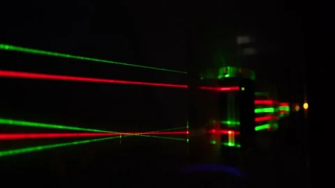 Cutting edge optics with red and yellow laser beams crossing at one point Stock Footage 229485344