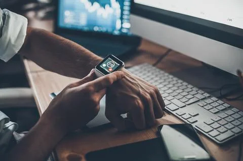 Cutting edge technology. Close-up of young businessman using smart watch wh.. Фото