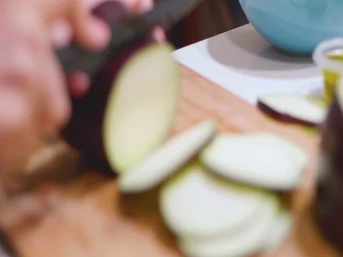 Cutting an egg plant in slow motion Stock Footage 80544932