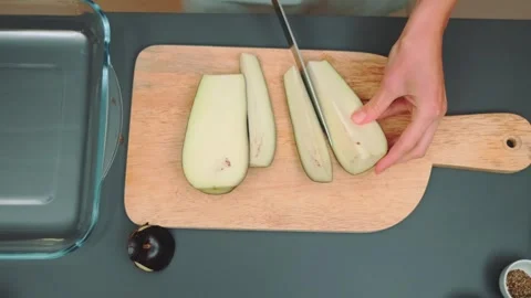 Cutting eggplant with a knife on a cutting board Stock-Footage 252194326