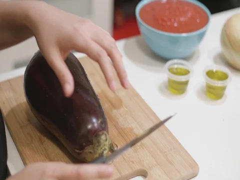 Cutting an eggplant in slow motion Stock Footage 80543532