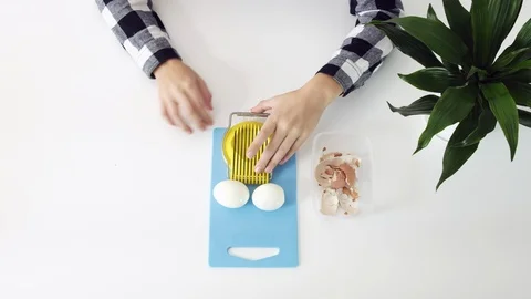 Cutting eggs of egg slicer on board close-up. Boiled eggs Stock Footage 102781152