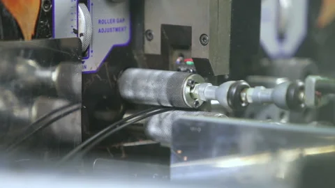 Cutting an electrical cable by a machine in production. Stock Footage 165577185