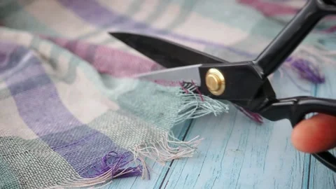 Cutting fabric with colorful threads for a sewing project Stock Footage 345185946