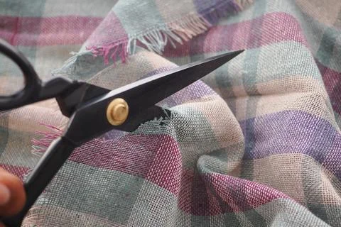 Cutting fabric with scissors for sewing Stock Photos