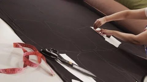 Cutting fabric on a table. Stock Footage 244732791
