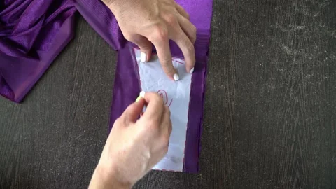 Cutting fabric, top view. Women's hands. Close-up 動画素材 195089652