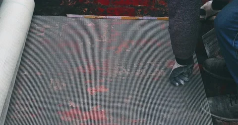 Cutting facade grid on construction site. Building worker cutting plastic gri 動画素材 169571352