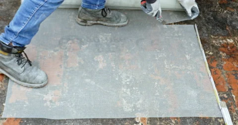 Cutting facade grid on construction site. Building worker cutting plastic gri Video stock 201024844