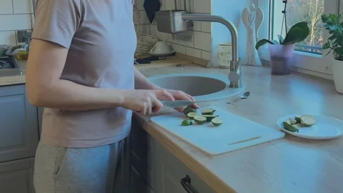 Cutting Feijoa Fruit On White Board Preparing Healthy Snack Close Kitchen Scene Video stock 336451260