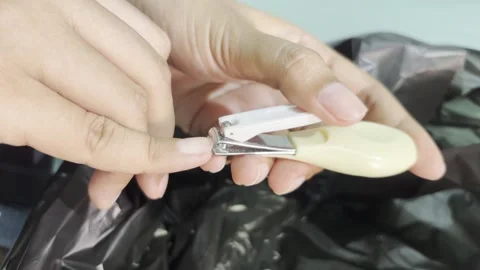 Cutting fingernails with nail clipper Video stock 345882854