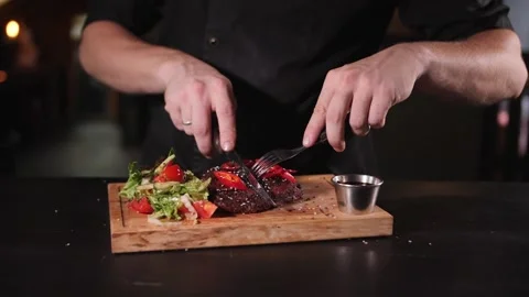 Cutting a finished beef steak with a knife Stock Footage 158329829