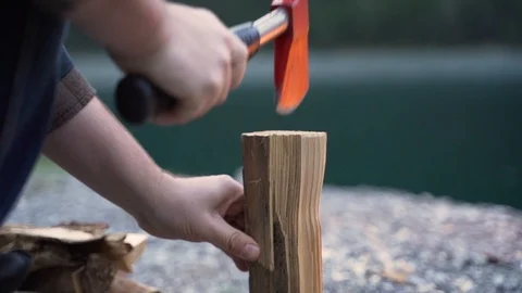 Cutting firewood with an red axe splitting in half Stock-Footage 120189678