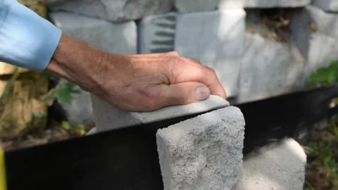 Cutting foam concrete blocks with a hacksaw. Stock Footage 315751245