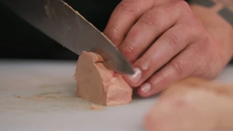 Cutting foie gras with a knife raw lunch condiment preparation freshness hands Stock Footage 103288100