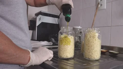 Cutting in food processor, mixing with olive oil and making garlic conserves. Stock Footage 148747680