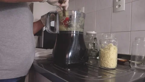 Cutting in food processor, mixing with olive oil and making garlic conserves. Stock Footage 148747755