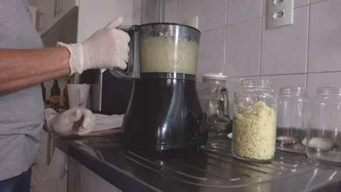 Cutting in food processor, mixing with olive oil and making garlic conserves. Stock Footage 148747892
