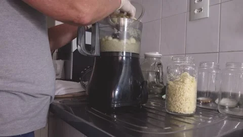 Cutting in food processor, mixing with olive oil and making garlic conserves. Stock Footage 148748006