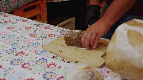 Cutting Fresh Bread at a Local Market Stall Stock Footage 345694967