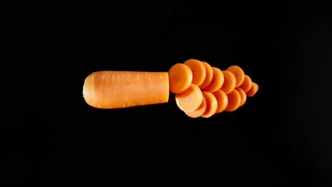 Cutting A Fresh Carrot On A Black Table, Stop motion Stock Footage 147369802