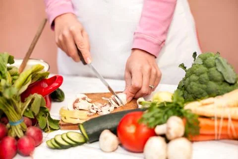 Cutting of fresh champignons in the kitchen Stock Photos