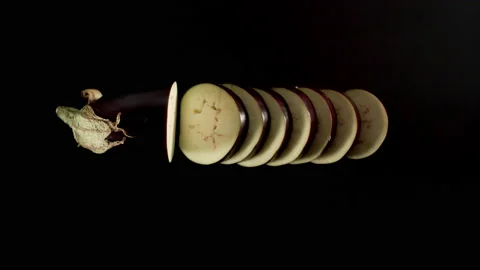 Cutting A Fresh Eggplant On A Black table, stop motion Stock Footage 147369676