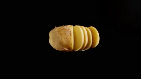 Cutting A Fresh Potato On A Black Table, Stop motion Stock Footage 147369703