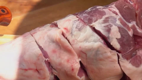 Cutting fresh raw leg of lamb Stock Footage 327458433