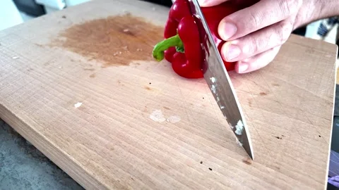 Cutting fresh red bell pepper on wooden board Video stock 345082798