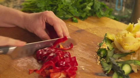Cutting fresh red pepper with a knife on a wooden board Stock-Footage 331314020