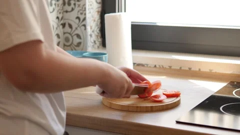 Cutting fresh vegetables in a modern kitchen. Space for culinary art Stock Footage 283478664