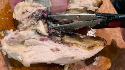Cutting fried chicken with kitchen scissors. Stock Footage 234547751