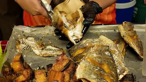 Cutting Fried Fish with Scissors Street Food Preparation Process, 4K Stock Footage 331984228