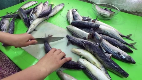Cutting frozen fish on the table. Mackerel. Frozen fish. Cut the fish. Stock Footage 83964357