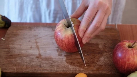Cutting fruit on the kitchen table. Stock Footage 89115734