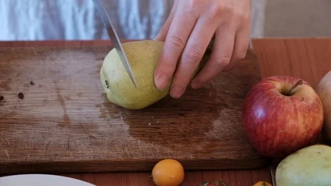 Cutting fruit on the kitchen table. Stock Footage 89120248
