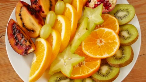 Cutting fruit on a plate 스톡 동영상 232250545