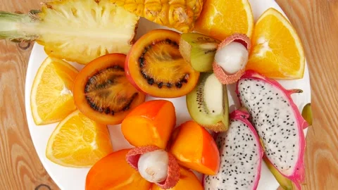 Cutting fruit on a plate Video stock 233238188