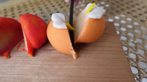 Cutting a Fruit-Shaped Mousse Cake with Flower Fondant Topping Close-Up Stock-Footage 345293687