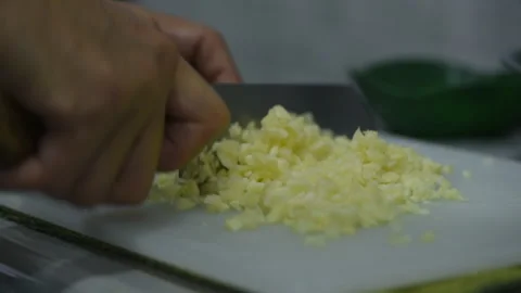 Cutting garlic on chopping board Stock Footage 193400001