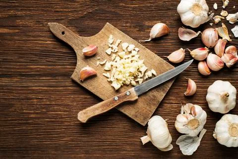 Cutting Garlic with a knife Stock Photos