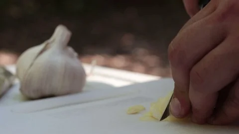 Cutting Garlic Pieces Outside Stock Footage 75819447
