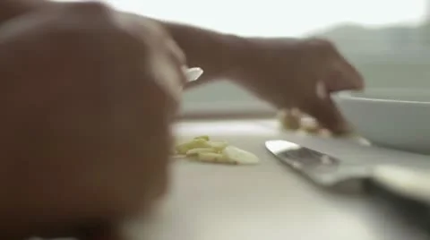 Cutting garlic into slices Stock Footage 12139348