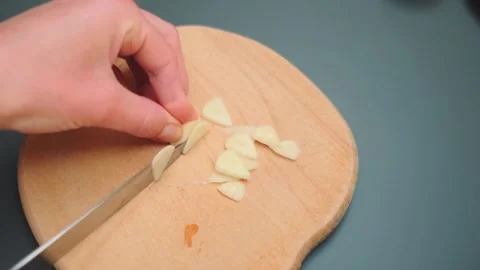 Cutting garlic into small pieces Stock Footage 249435579