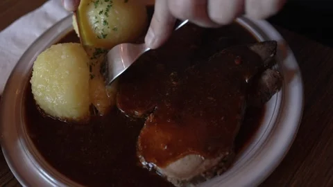 Cutting German Dumplings and Beef Stock Footage 330499734