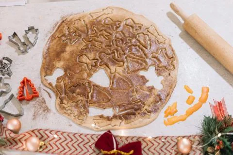 Cutting the gingerbread cookie dough to make tasty biscuits for Christmas and Stock Photos